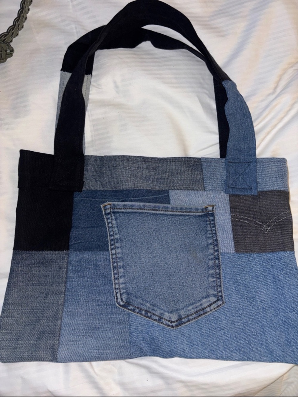 DENIM TOTE BAG MADE UP OF ALL DIFFERENT SWATCHES OF DENIM POCKET ON THE OUTSIDE